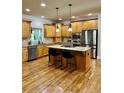 Spacious kitchen with island and stainless appliances at 89 Grand Oak Way, Dallas, GA 30157