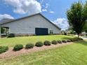 Gray house exterior with landscaped yard and partial view of neighborhood at 310 Ellington Dr, Canton, GA 30115