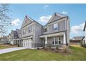 Two-story house with stone and gray exterior, three-car garage, and a front yard at 1522 Dover Creek Ln, Lawrenceville, GA 30045