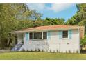 Ranch home with light brick exterior and blue shutters at 822 Gertrude Nw Pl, Atlanta, GA 30318