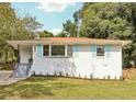 Ranch home with light brick exterior and blue shutters at 822 Gertrude Nw Pl, Atlanta, GA 30318