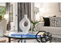 Stylish coffee table with modern decor, including a vase, book, and plant at 46 Monet Nw Ct, Atlanta, GA 30327