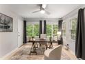 Sunlit home office featuring a workspace with a wooden desk and ample natural light at 46 Monet Nw Ct, Atlanta, GA 30327