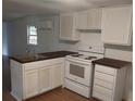 Cozy kitchen featuring white cabinets, wood countertops, and modern appliances at 64 Luther Knight Se Rd, Cartersville, GA 30121