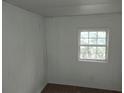 Simple bedroom with wood flooring and beadboard walls at 64 Luther Knight Se Rd, Cartersville, GA 30121