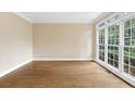 Bright sunroom with hardwood floors and large windows at 8033 Allerton Ln, Cumming, GA 30041