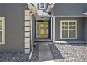 Front entry with yellow door, stone pathway, and gray exterior at 103 Royal Way, Mcdonough, GA 30252
