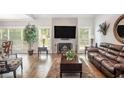 Spacious living room with hardwood floors, fireplace, and large TV at 103 Royal Way, Mcdonough, GA 30252