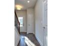 Sunlit foyer with wood-look floors and staircase at 6186 Ripple Way # 84, South Fulton, GA 30349