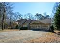 Spacious home with a three-car garage and a large driveway at 6865 Cowan Mill Rd, Winston, GA 30187