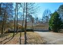 Charming house nestled in a wooded setting with a three-car garage at 6865 Cowan Mill Rd, Winston, GA 30187