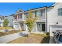 Two-story townhome with attached garage and landscaping at 3511 Lakeview Crk, Lithonia, GA 30038