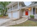 House exterior showcasing front entrance, walkway, and two-car garage at 1123 Redan Way, Stone Mountain, GA 30088