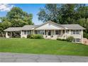 Brick ranch house with carport and well-manicured lawn at 3216 Guynelle Dr, Marietta, GA 30066