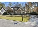 House exterior showcasing a driveway and well-maintained lawn at 403 Pebblebrooke Ln, Canton, GA 30115