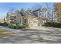 Side view of the house, highlighting the garage and landscaping at 403 Pebblebrooke Ln, Canton, GA 30115