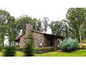 Rustic stone house with a covered porch nestled in the woods at 1625 Brushy Mountain Rd, Rockmart, GA 30153