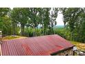 Aerial view of a rustic stone house with a metal roof and mountain views at 1625 Brushy Mountain Rd, Rockmart, GA 30153