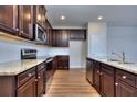 Dark wood cabinets, granite countertops, and stainless steel appliances in this kitchen at 6190 Ripple Way # 85, South Fulton, GA 30349