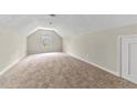 Spacious bonus room with neutral carpet and ample natural light at 1870 Rocksram Dr, Buford, GA 30519