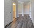 Gray vinyl flooring in a hallway with white doors and views into other rooms at 111 Sunflower Ne Cir, Cartersville, GA 30121