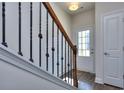 Bright entryway with hardwood floors, an elegant staircase, and a coat closet at 6194 Ripple Way # 86, South Fulton, GA 30349