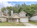 Tan two-story house with a garage and porch at 217 Maple Nw St, Atlanta, GA 30314