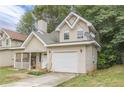 Tan two-story house with a garage and porch at 217 Maple Nw St, Atlanta, GA 30314