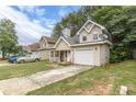 Tan two-story house with attached garage, front yard, and driveway at 217 Maple Nw St, Atlanta, GA 30314