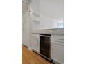 Modern kitchen with white cabinets, granite countertops, and stainless steel appliances at 3060 Pharr Court North Nw # 317, Atlanta, GA 30305