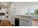 Updated kitchen features granite countertops, stainless steel appliances, and in-unit laundry at 3060 Pharr Court North Nw # 317, Atlanta, GA 30305