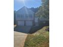 Two-story house with double garage and brick accents at 15 Lumby Ln, Covington, GA 30016