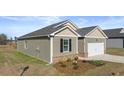 One-story house with a two-car garage and landscaping at 8588 Preakness Pass, Lithonia, GA 30058