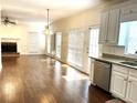 Kitchen with hardwood floors, stainless steel appliances, and access to backyard at 221 Larkshyre Trl, Lawrenceville, GA 30043