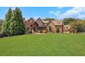 Brick house with large lawn and driveway at 2145 Jones Phillips Rd, Dacula, GA 30019