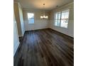 Spacious dining room with hardwood floors and wainscoting at 3627 Lockaby Way, Lawrenceville, GA 30044
