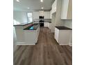 Modern kitchen with island and granite countertops at 3627 Lockaby Way, Lawrenceville, GA 30044