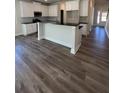 Modern kitchen with island and hardwood floors at 3627 Lockaby Way, Lawrenceville, GA 30044