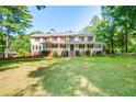 Two-story house with wrap-around porch and spacious lawn at 3060 Orchard Sw Rd, Conyers, GA 30094
