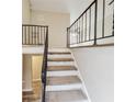 Carpeted staircase with metal railing leading to the upper level at 2900 Bradmoor Ct, Decatur, GA 30034