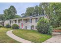 Brick ranch house with red door and landscaping at 3993 Snapfinger Way, Decatur, GA 30035