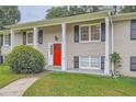 Brick ranch house with red door and landscaping at 3993 Snapfinger Way, Decatur, GA 30035