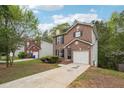 Two-story home with a driveway and landscaping at 4029 Riverside Pkwy, Decatur, GA 30034
