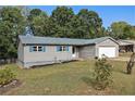 One-story house with gray siding, white garage door, and blue shutters at 315 Watts Rd, Hiram, GA 30141