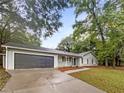 Newly renovated house exterior boasts a gray exterior, and a dark gray garage door at 4762 Huntsman Bnd, Decatur, GA 30034