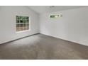 Bright bedroom with grey carpet and large window at 1140 Independence Way, Norcross, GA 30093