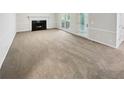 Living room with fireplace and access to backyard patio at 709 Tribal Trl, Woodstock, GA 30188
