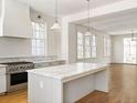 Open concept kitchen with island, hardwood floors, and a view to the living room at 2701 Southwell St, Atlanta, GA 30305