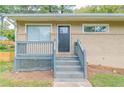 Front porch with gray railing and steps leading to the front door at 1278 Lynwyn Se Ln, Atlanta, GA 30316