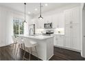 Modern kitchen with white cabinets, stainless steel appliances, and island at 201 Devore Rd, Alpharetta, GA 30009